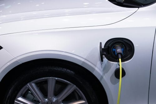 electric car being charged zoomed on charging socket