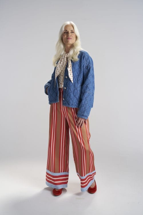 woman-wearing-bright-clothing-with-blue-shirt-and-red-light-red-striped-pants